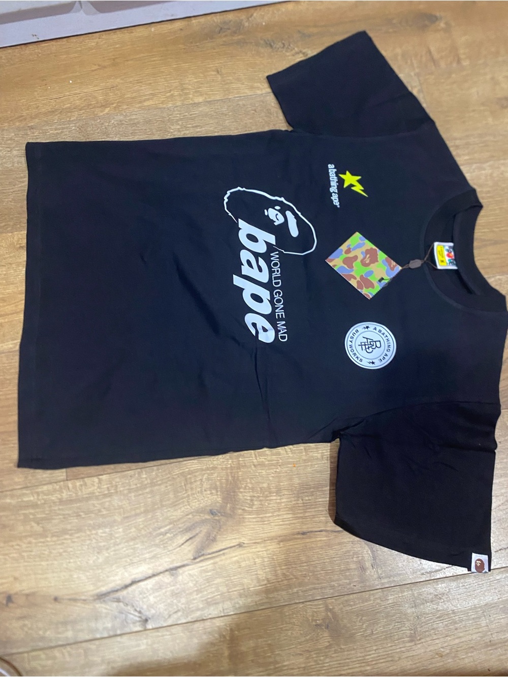 Bape short-sleeve tee with graphic text ”WORLD GONE MAD BAPE”